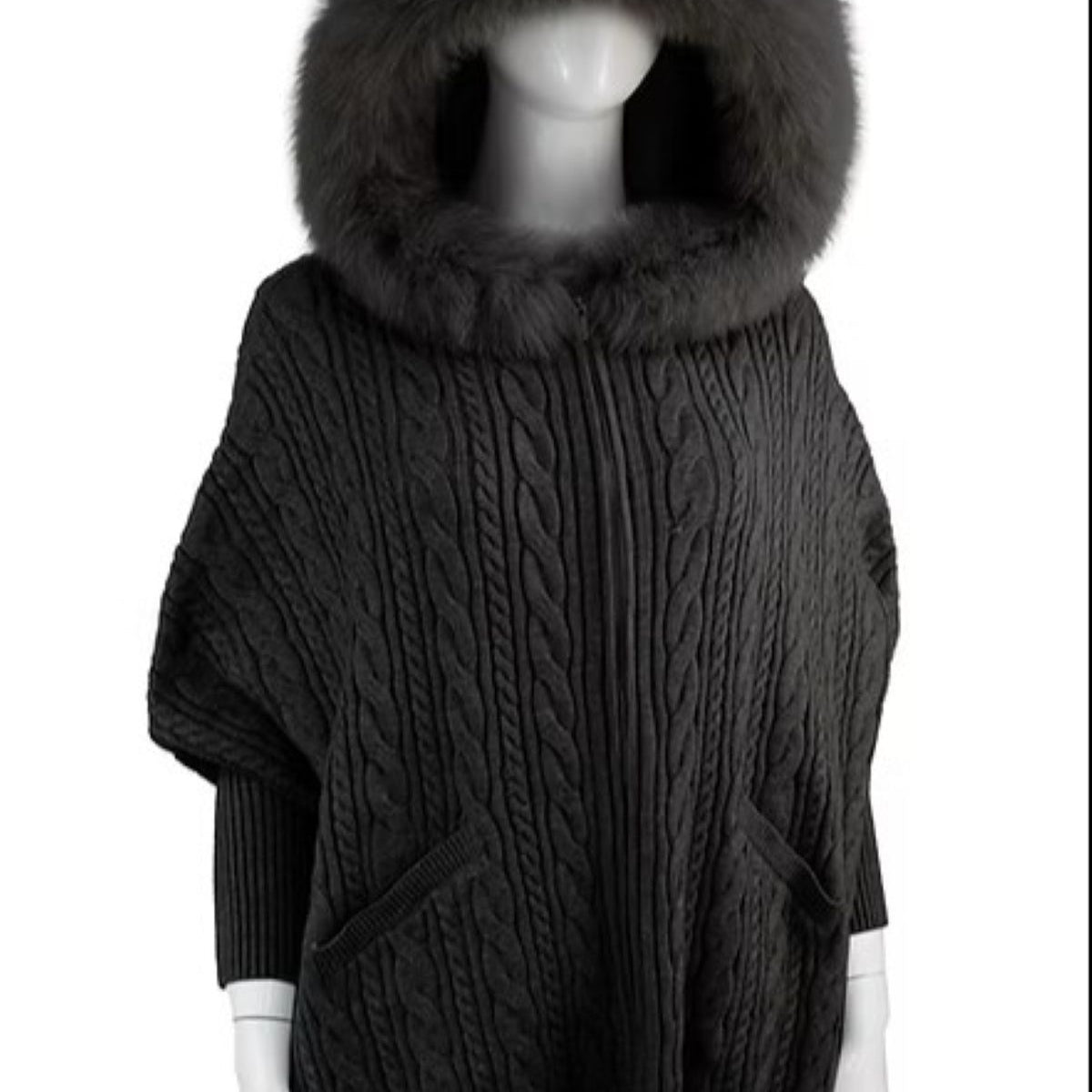 Dark gray cable knit poncho with a large fur hood on a mannequin against a white background