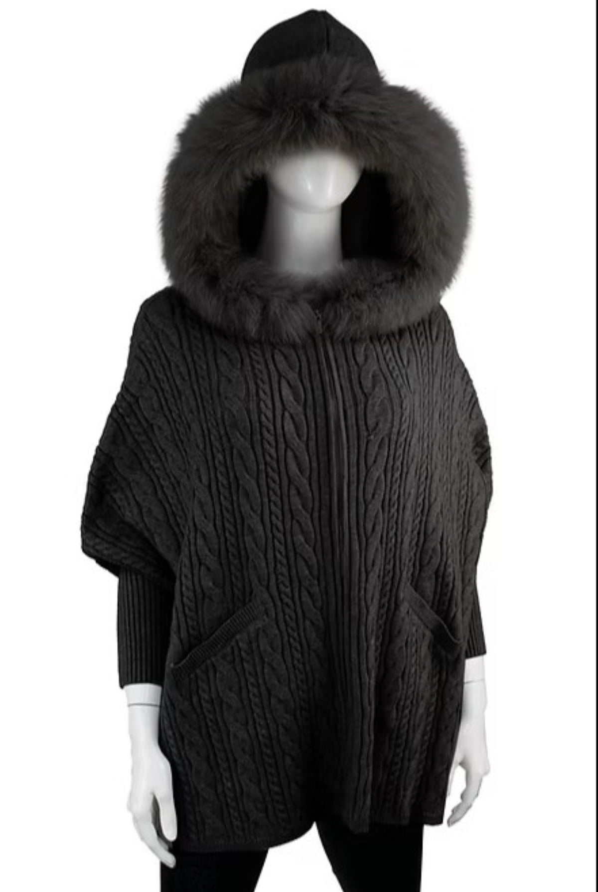 Dark gray cable knit poncho with a large fur hood on a mannequin against a white background