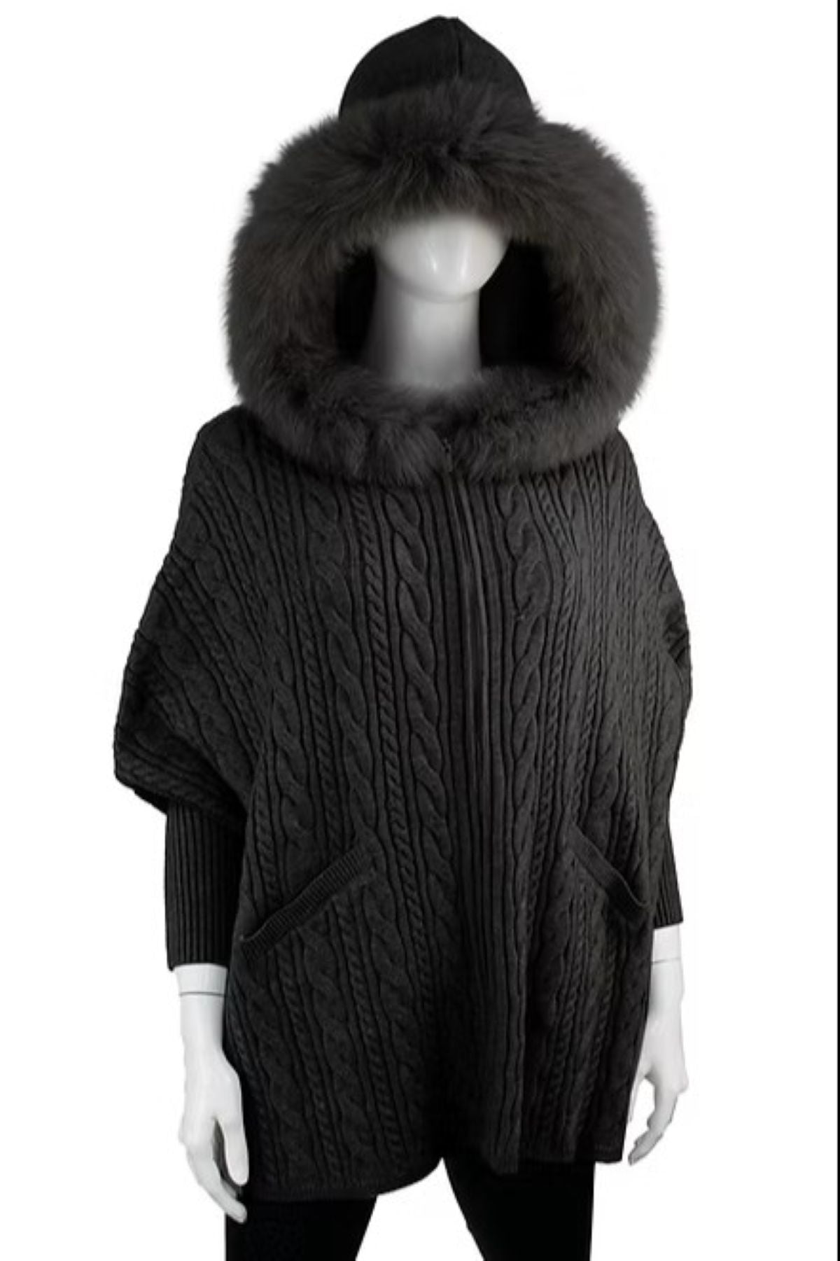 Dark gray cable knit poncho with a large fur hood on a mannequin against a white background